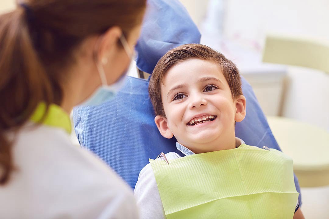 A child with a dentist in a dental office. Children’s Dentistry